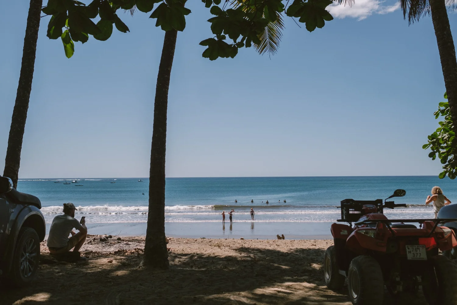 Palm trees framing the beach and ocean in Nosara