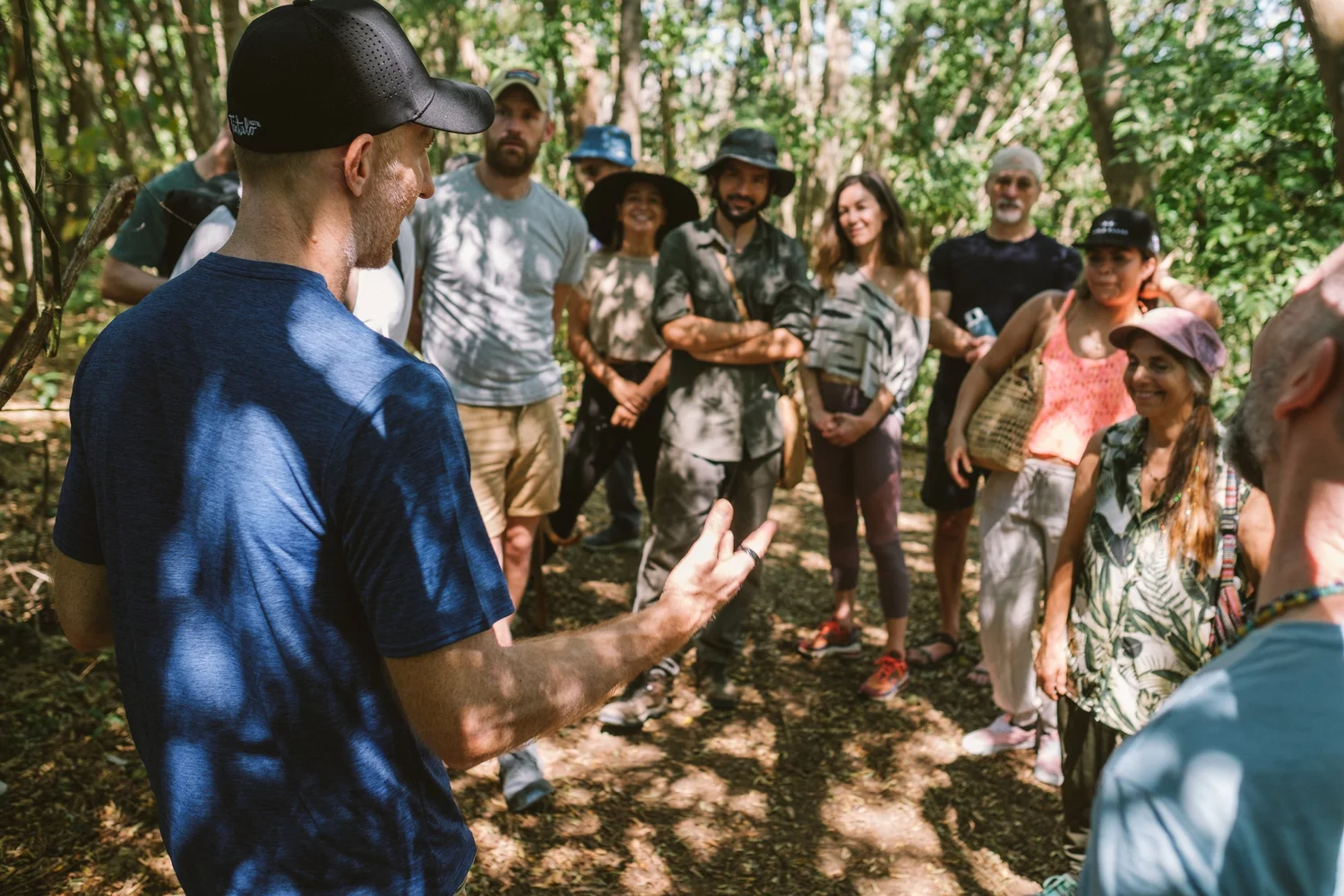 Group of visitors listening to a guide on a forest walk