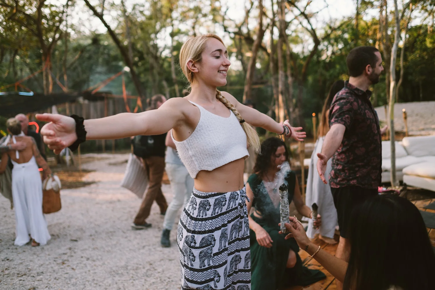 Woman dancing outdoors with friends at a community gathering