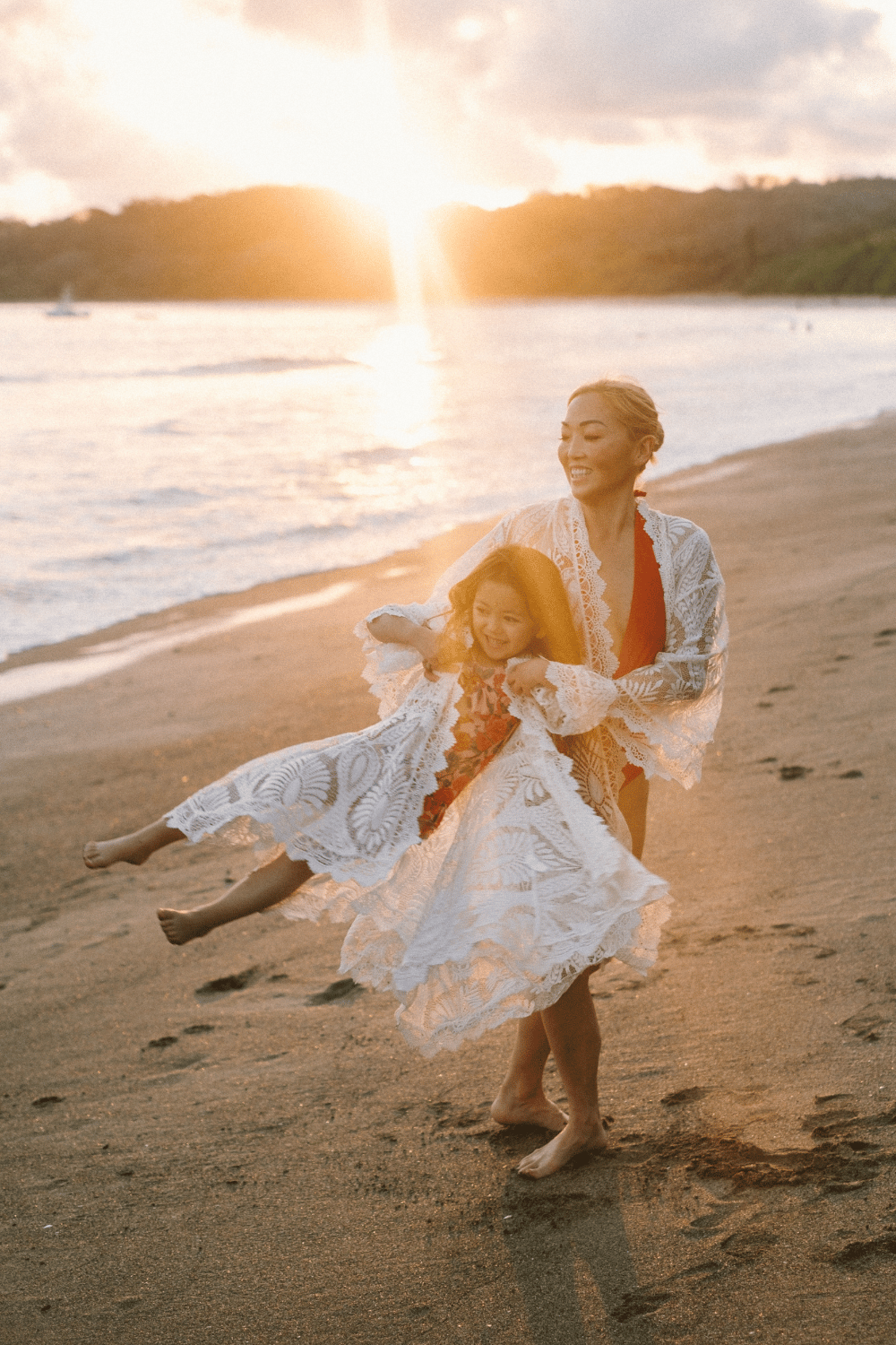 A parent and child playing together on a sunset beach in Nosara