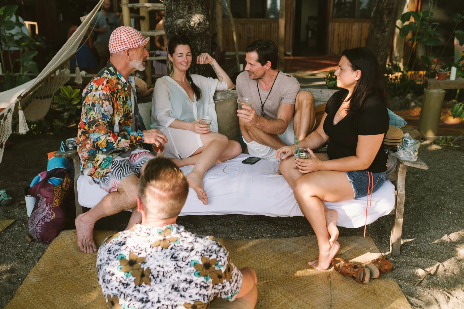 Friends talking and relaxing together on an outdoor lounge